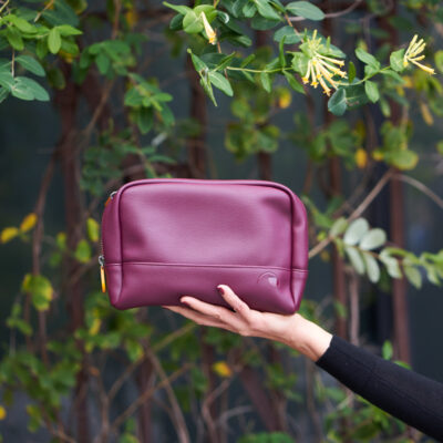 burgundy makeup and cosmetics bag with double zipper and interior pockets